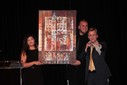 Joe Cressy, Director of Campaigns and Community Outreach at the Stephen Lewis Foundation, auctions a painting by Lubna Mousa.